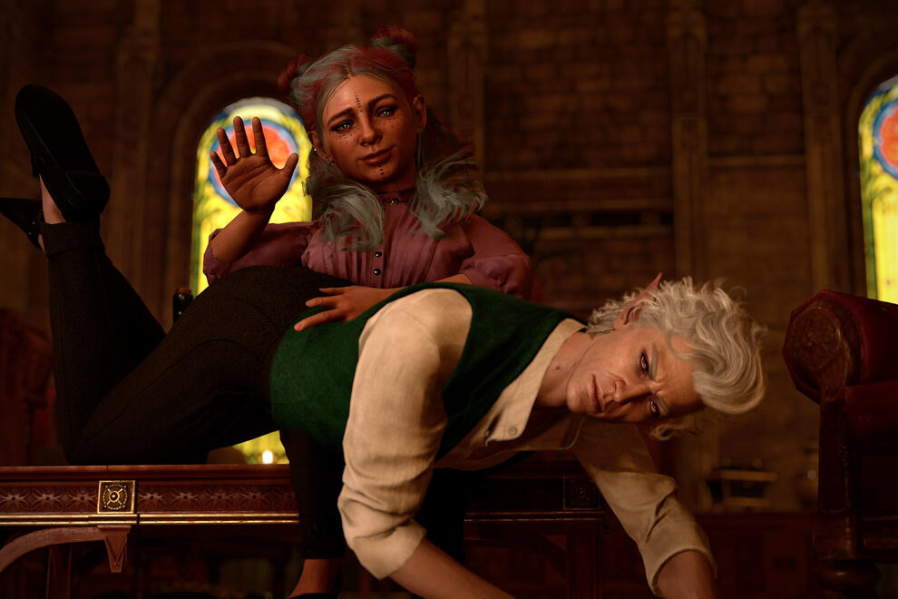 Raviol is sitting on a coffee table with a proud smile. Astarion is draped over her knees with a grimace. She's about to slap his butt.